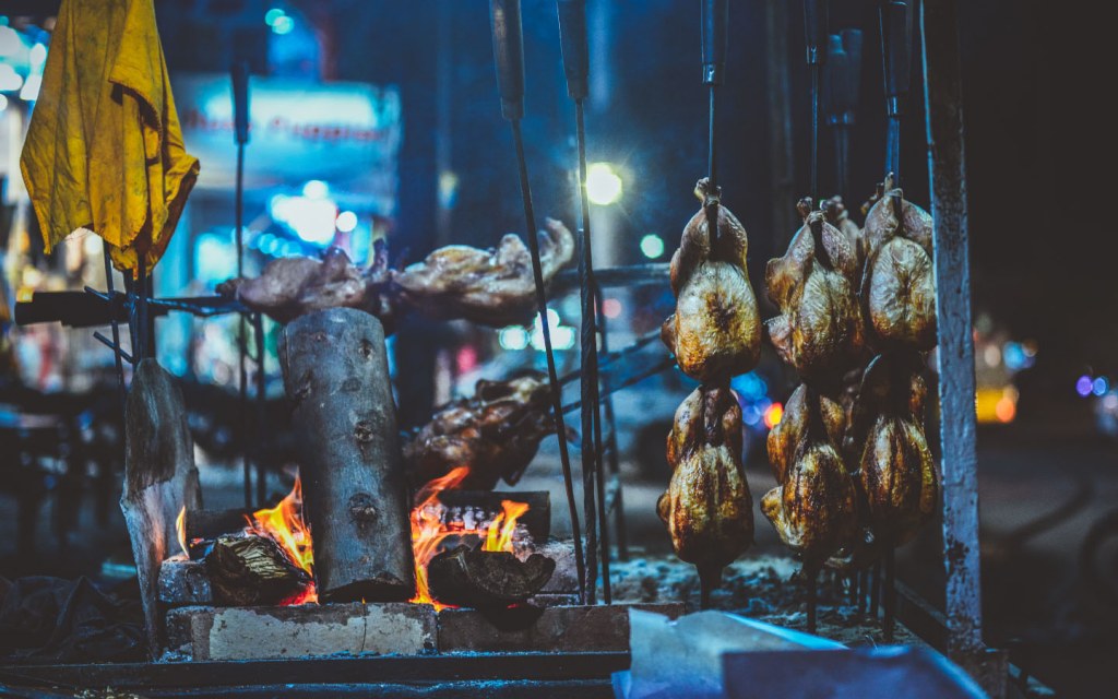 Balochi sajji being cooked on hot coals