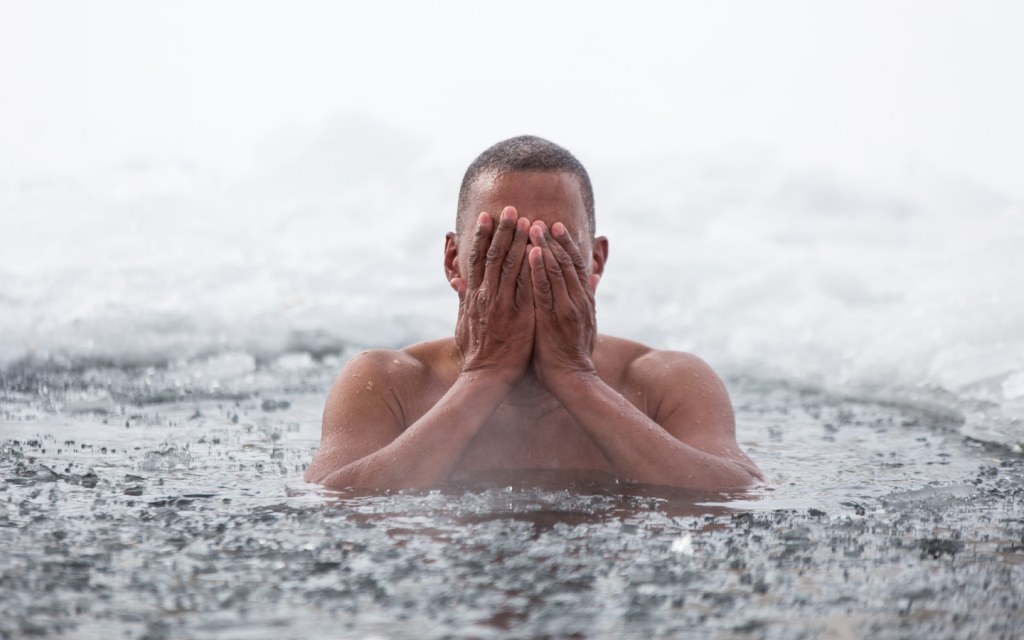 Man Swimming in Icy Water