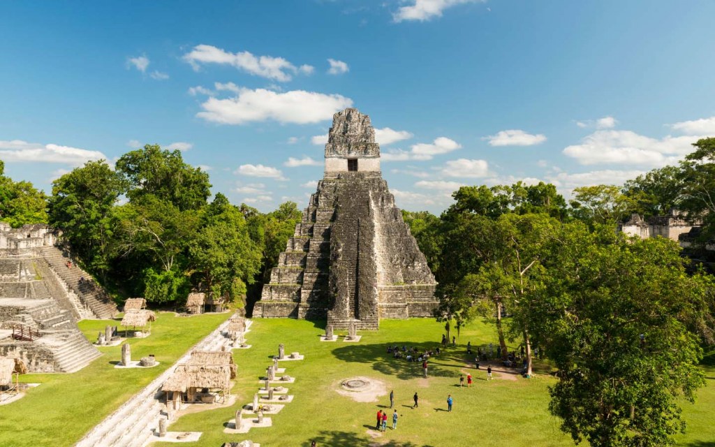 People view the Jaguar Temple in Tikal National Park in Guatemala