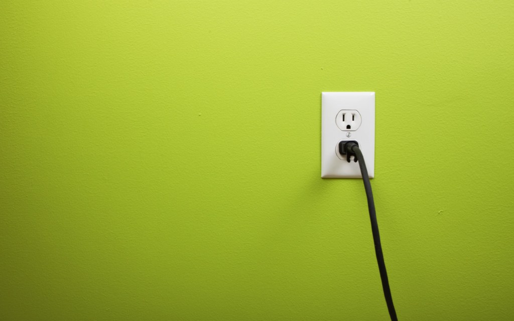Electrical outlet on lime green wall