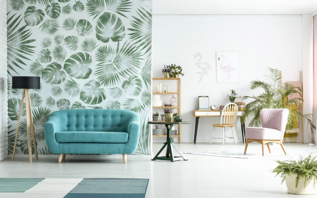 Modern room with green wallpaper and blue couch
