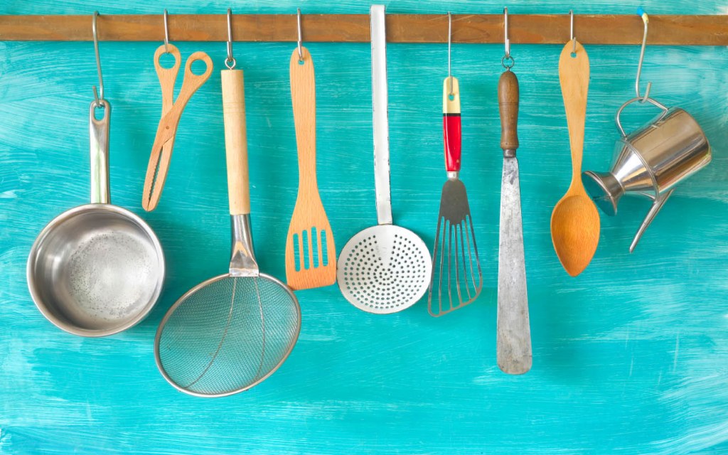 Make the most of your kitchen wall by hanging pots pans and spoons