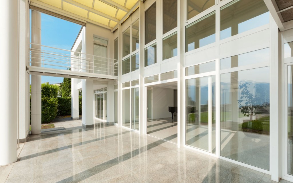 Modern house construction companies use glass doors and glass walls 