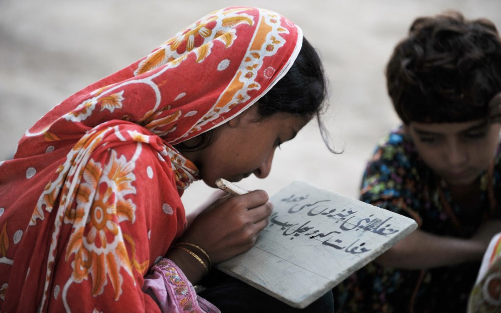 girl writing in urdu 