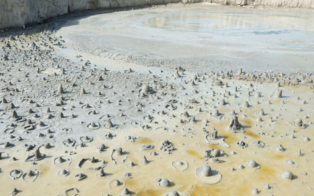 Mud volcanoes spew cold mud from the ground